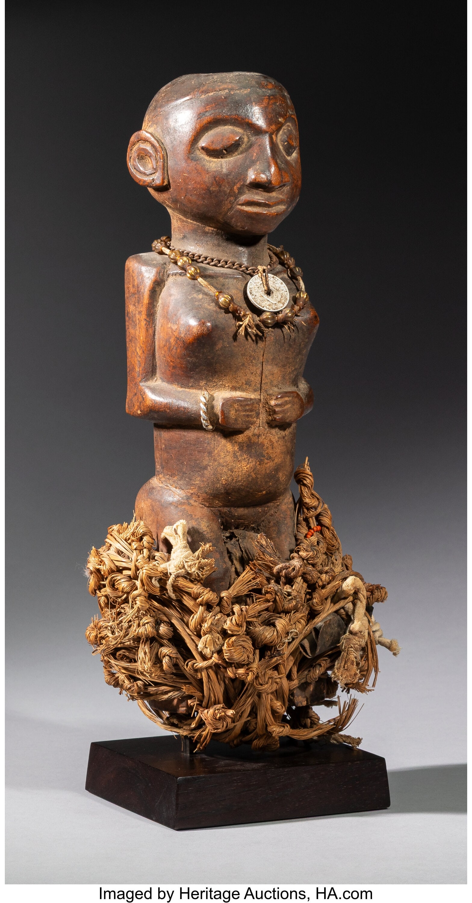 A Female Power Figure (Nkisi) Yaka or Zombo art: A Female Power Figure (Nkisi) Yaka or Zombo artist, Kwango region, Democratic Republic of Congo, c. Late 19th to early 20th century This compelling female nkisi pres