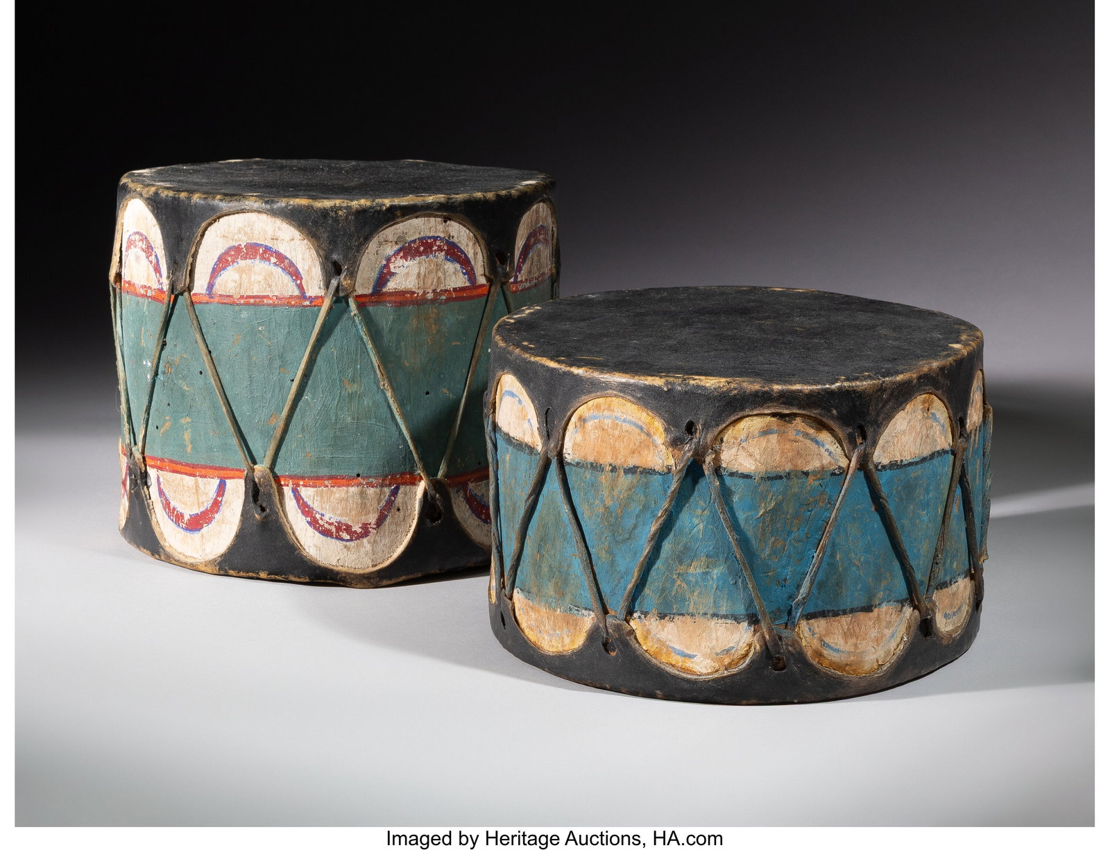 Two Cochiti Polychrome Drums c. 1940 wood, pa: Two Cochiti Polychrome Drums c. 1940 wood, paint, hide Diameters: 8 &frac34; inches each HID03101062020 © 2026 Heritage Auctions | All Rights Reserved www&p