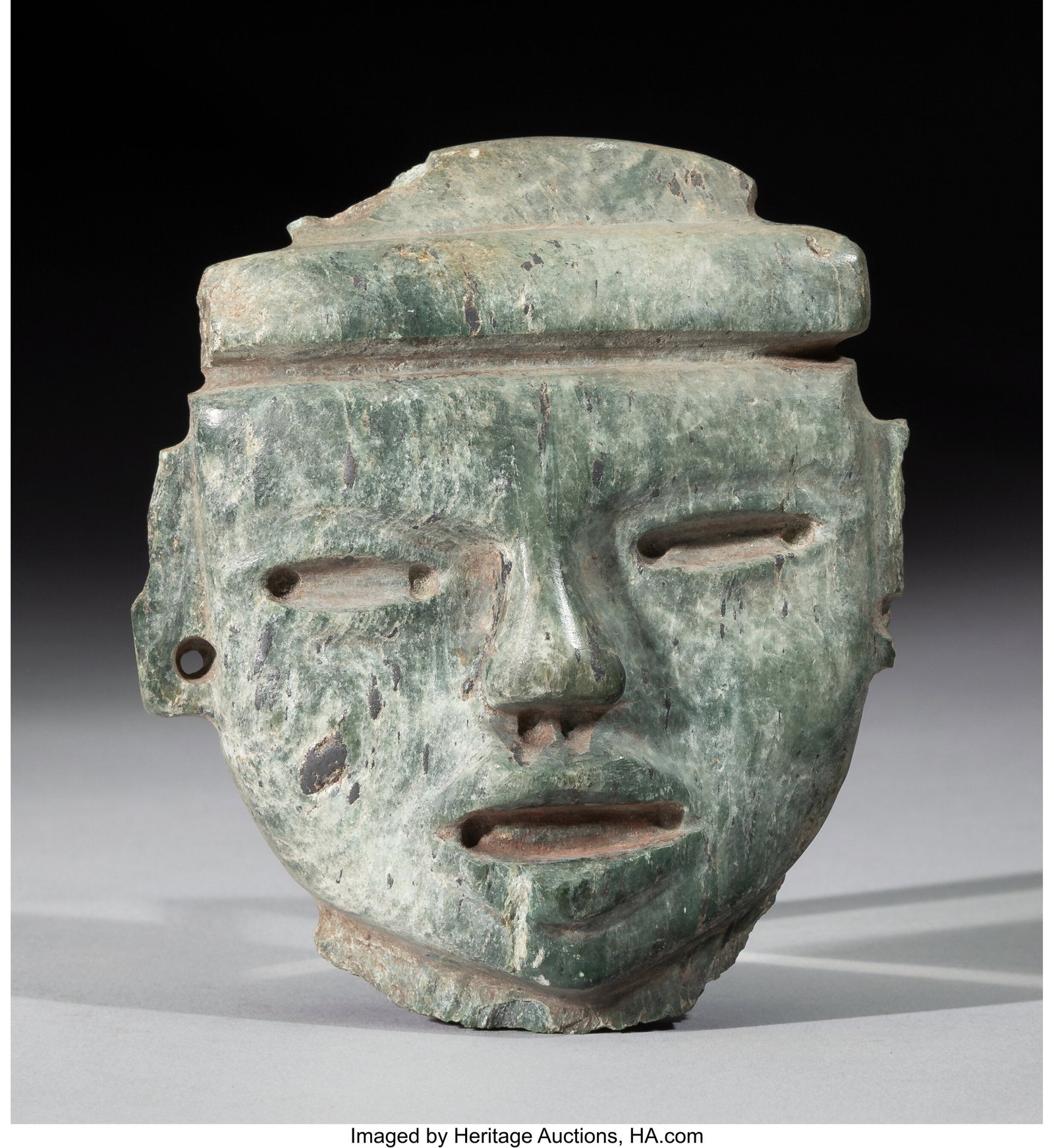 A Teotihuacan Stone Head A fragment from a lar: A Teotihuacan Stone Head A fragment from a large figure. Provenance: Property from the Private Collection of Dr. John Ross, Sr. Height: 4 &frac12;