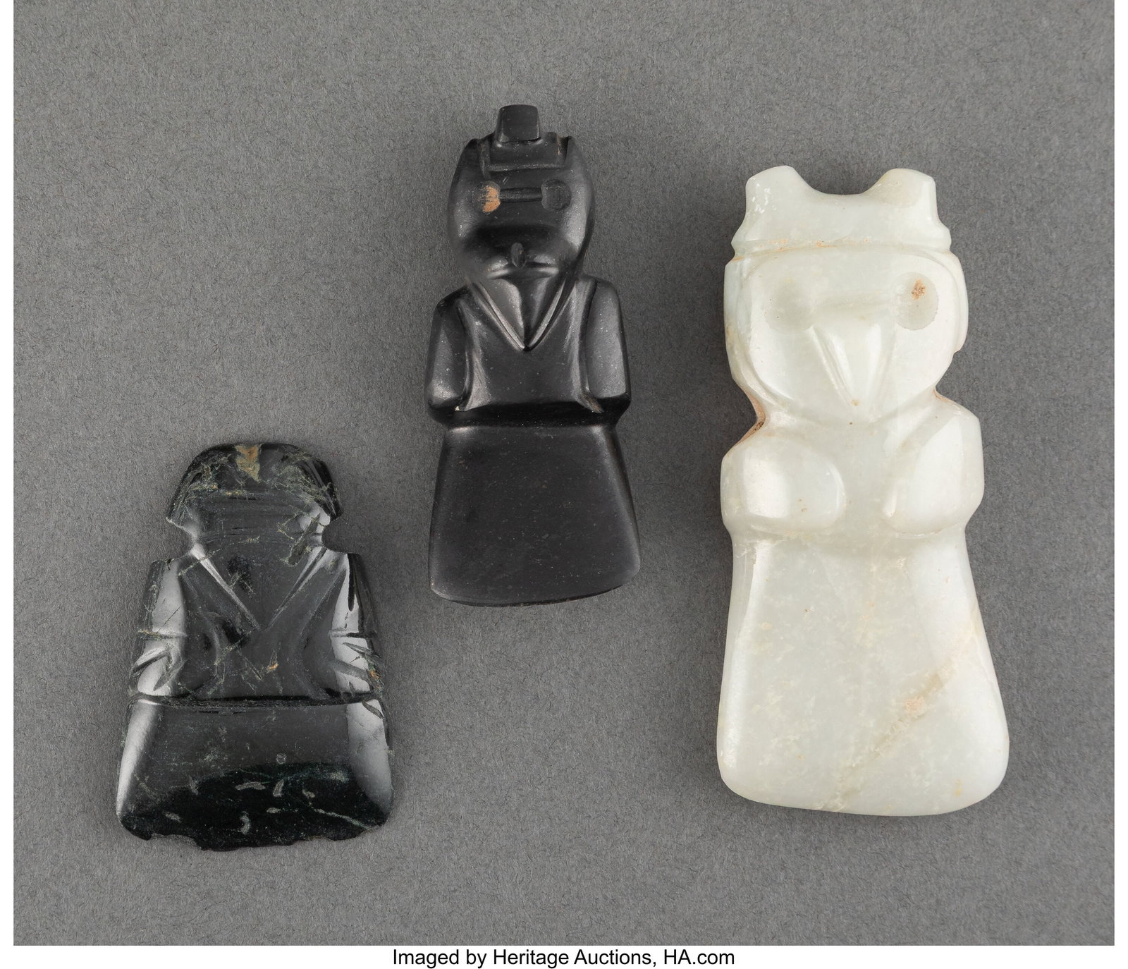 Three Jade Avian Axe God Pendants Costa Rica, c: Three Jade Avian Axe God Pendants Costa Rica, c. 100 - 700 Two black jade, one with a high gloss; the third carved from translucent white jade. All in excellent