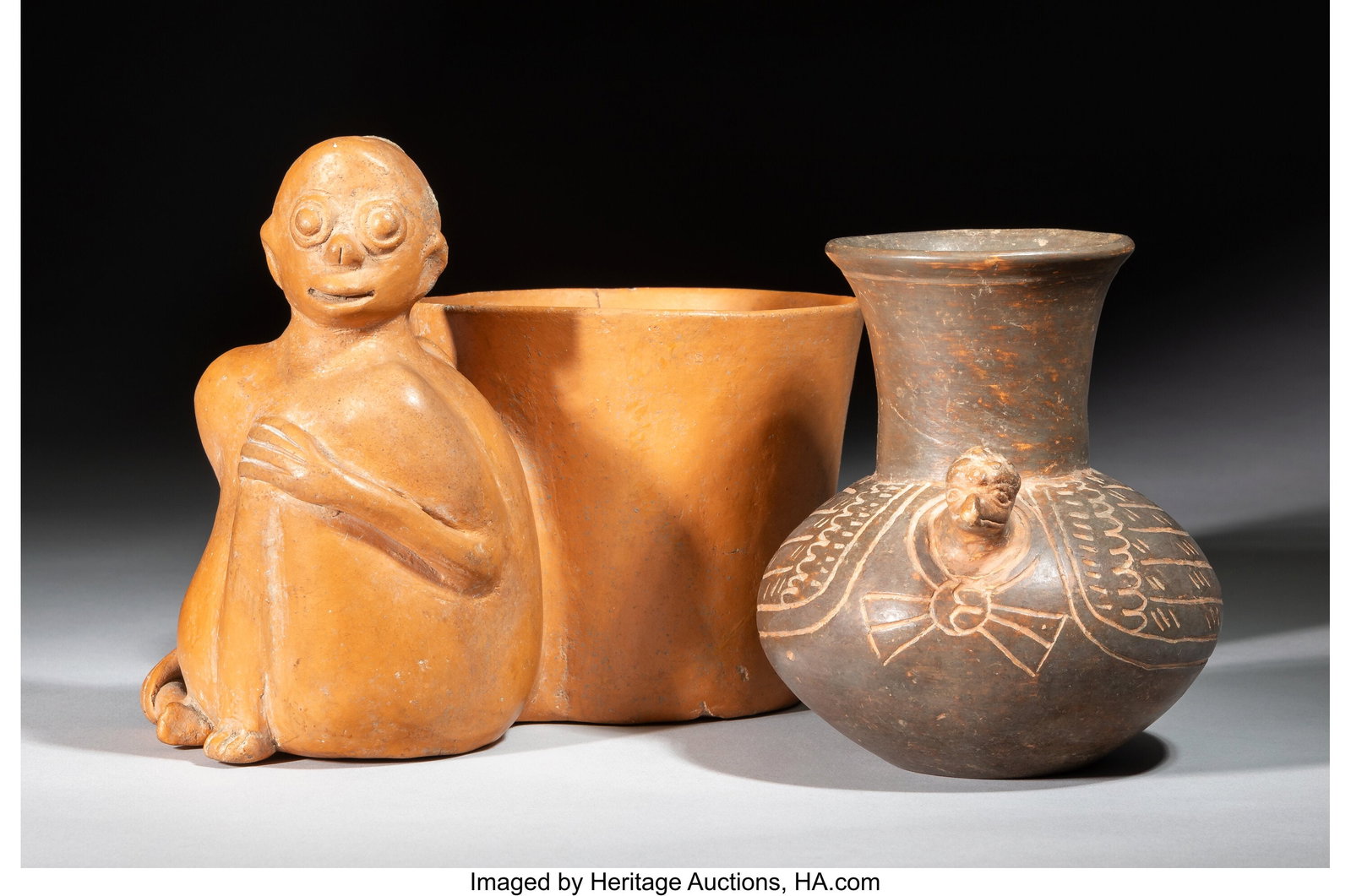 Two Maya Vessels Mesoamerica, c. 700-900 AD O: Two Maya Vessels Mesoamerica, c. 700-900 AD One a plumbate turkey vessel. The other an orangeware whistling vessel with a seated monkey forming one chamber attached by a channel
