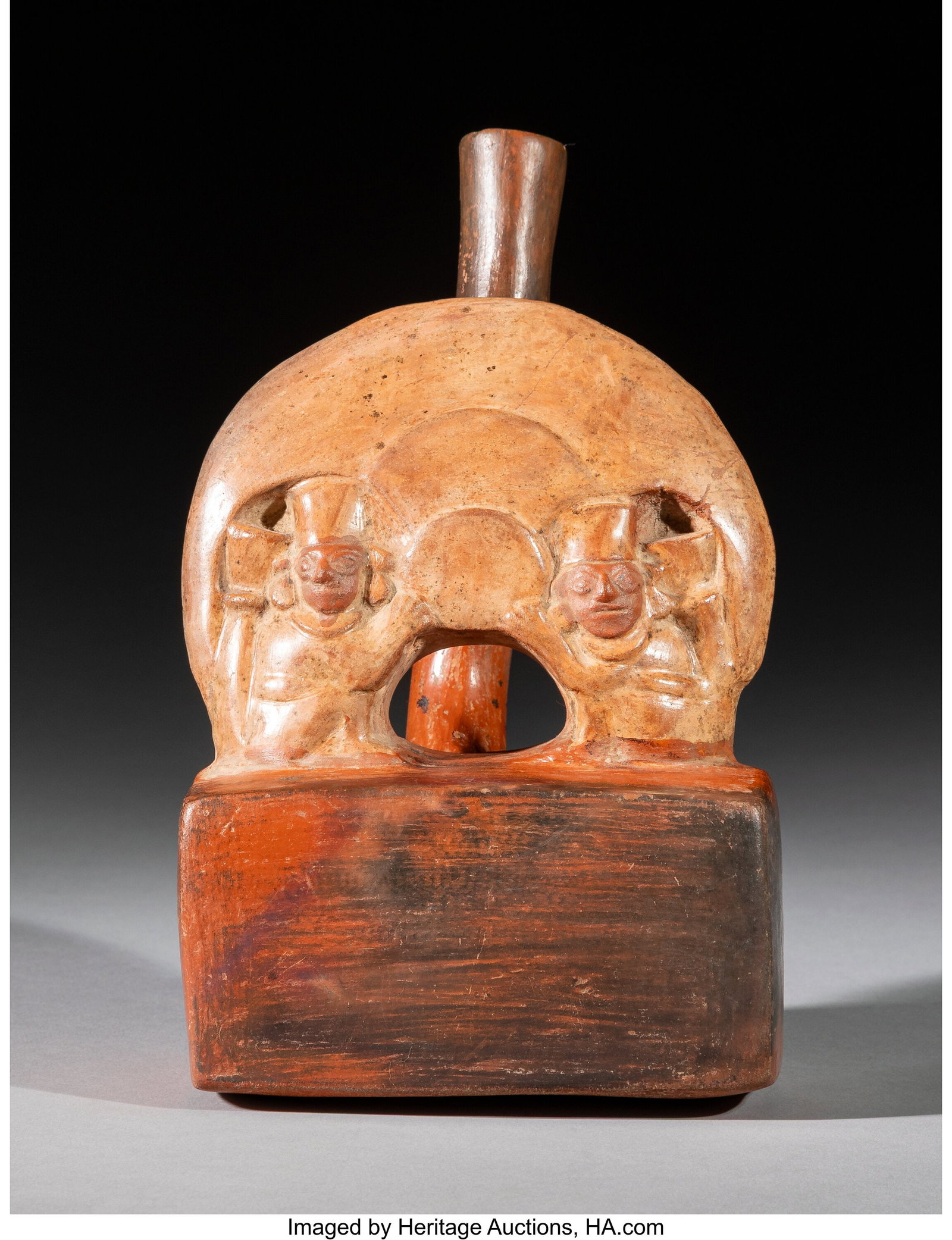 A Moche Stirrup Spout Vessel with Molded Scene o: A Moche Stirrup Spout Vessel with Molded Scene on Rectangular Chamber Height: 8 inches HID03101062020 © 2026 Heritage Auctions | All Rights Reserved