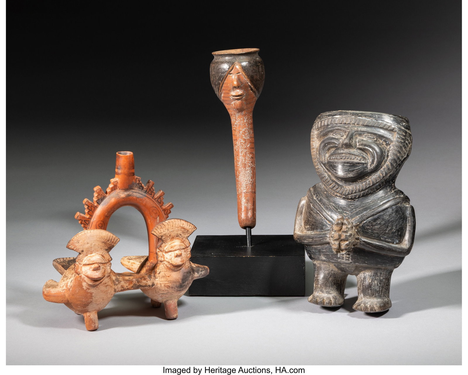 Three Peruvian Ceramic Items including a pipe: Three Peruvian Ceramic Items including a pipe; a stirrup-handled vessel with two human/bird figures; and a standing blackware figure Dimensions: ranging from 6 &frac12;