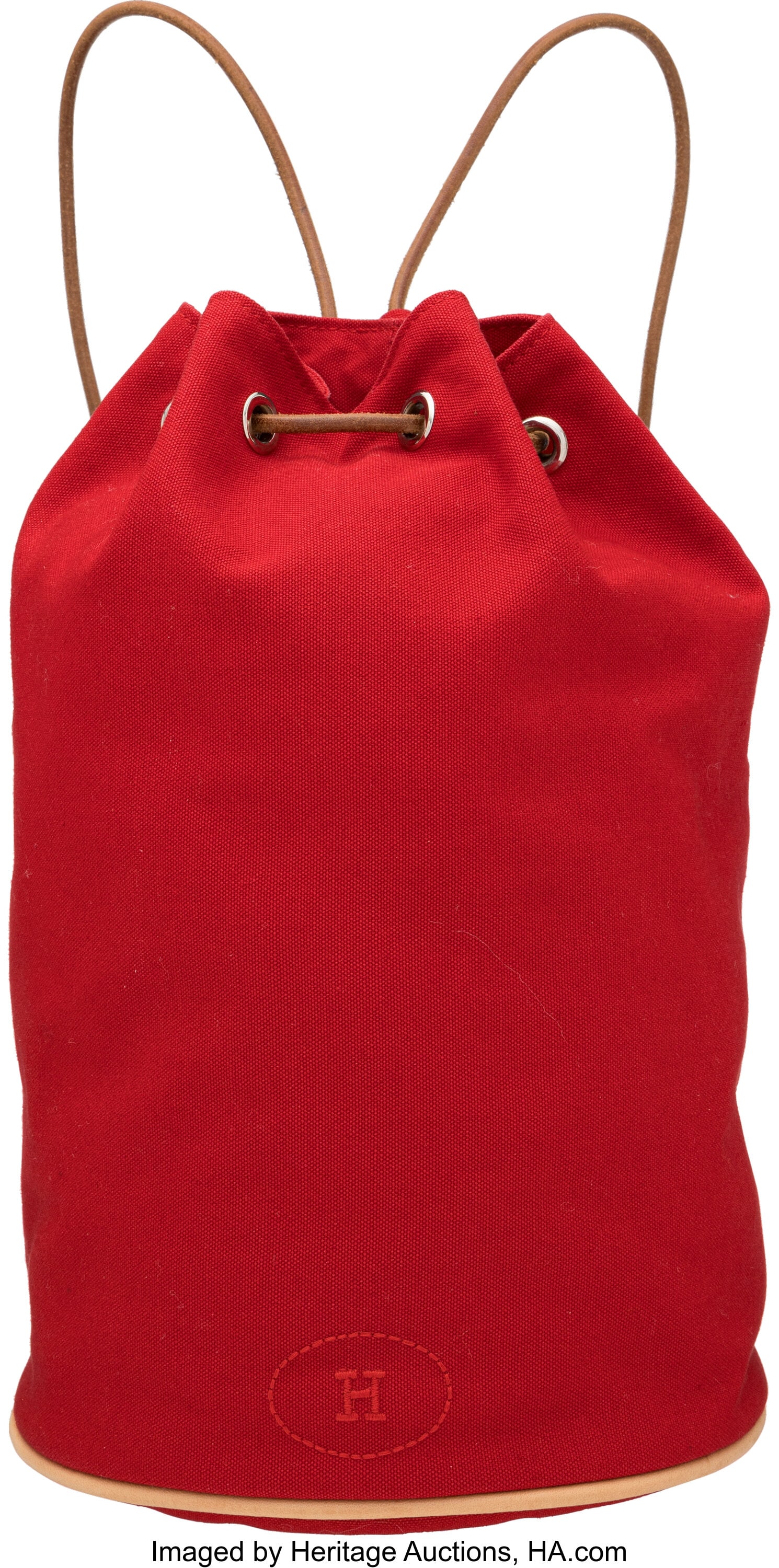 Hermès Red Canvas Polochon Mimile Drawstring Ba: Hermès Red Canvas Polochon Mimile Drawstring Bag with Palladium Hardware Condition: 2 7.5" Width x 12" Height x 7.5" Depth This bag is done in Red Canvas with Leather Trim a