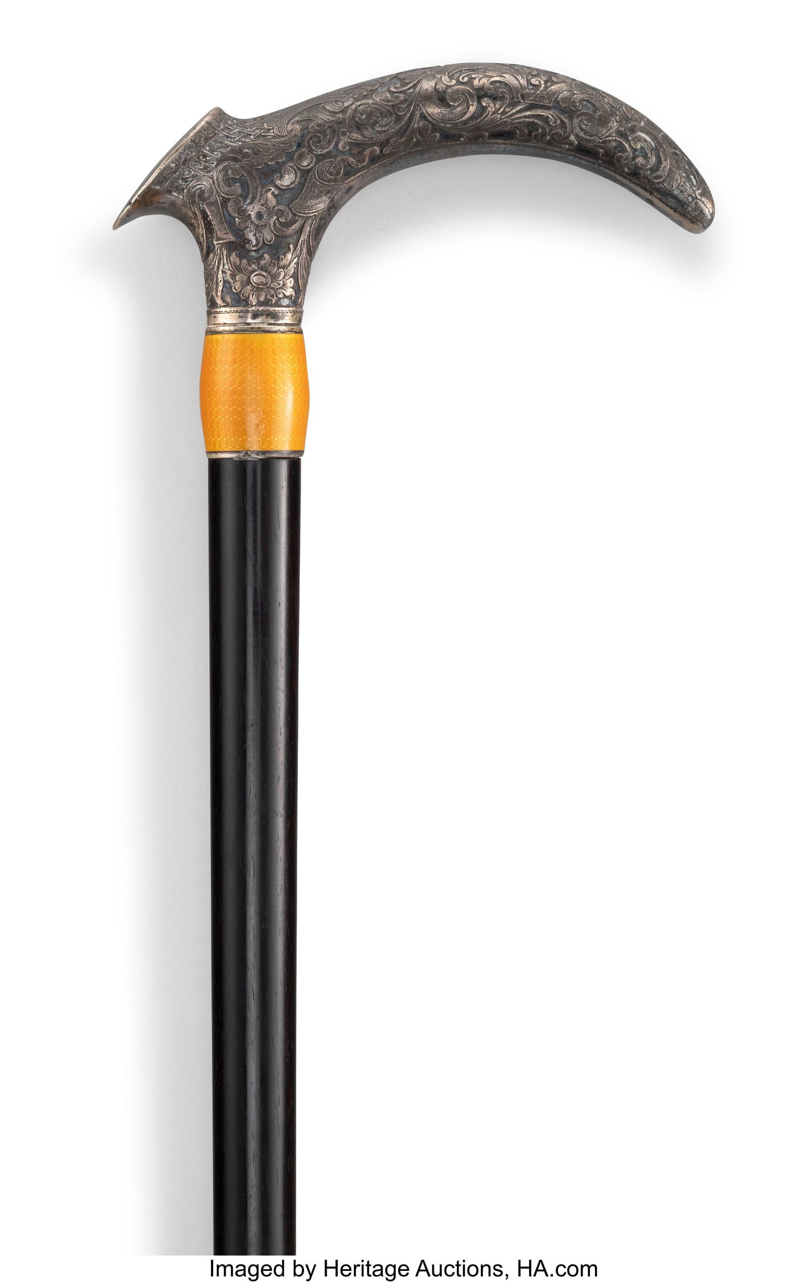 A Continental Guilloché Enameled Silver-Mounted: A Continental Guilloché Enameled Silver-Mounted and Ebonized Wood Cane, circa 1900 35 x 0-3/4 x 4-1/2 inches (88.9 x 1.9 x 11.4 cm) HID03101062020 &