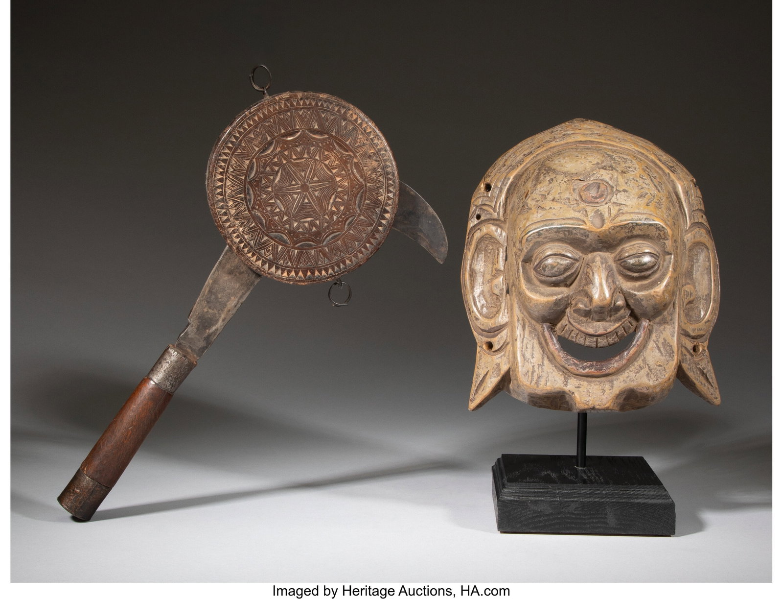 A Nepalese Sickle with Holder and A Tibetan Wood: A Nepalese Sickle with Holder and A Tibetan Wood Mask on Stand 14-7/8 x 8 x 1-1/2 inches (37.8 x 20.3 x 3.8 cm) (largest, sickle with holder) Pro