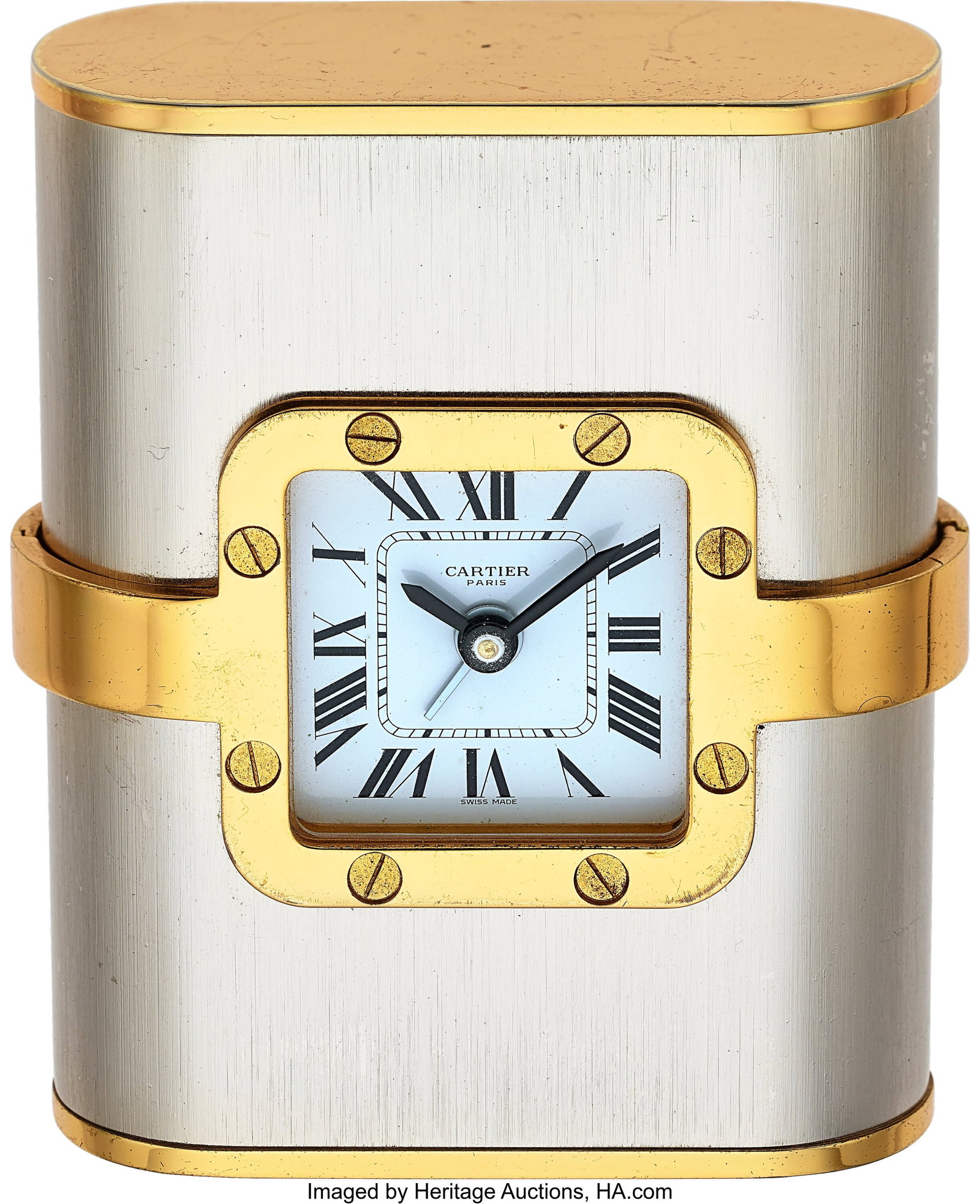 Cartier, Santos de Cartier "Pendulette", Table A: Cartier, Santos de Cartier "Pendulette", Table Alarm Clock Case: 67mm x 85mm, brass and steel, 7525 01221 Dial: white roman dial , black sword hands Movement&