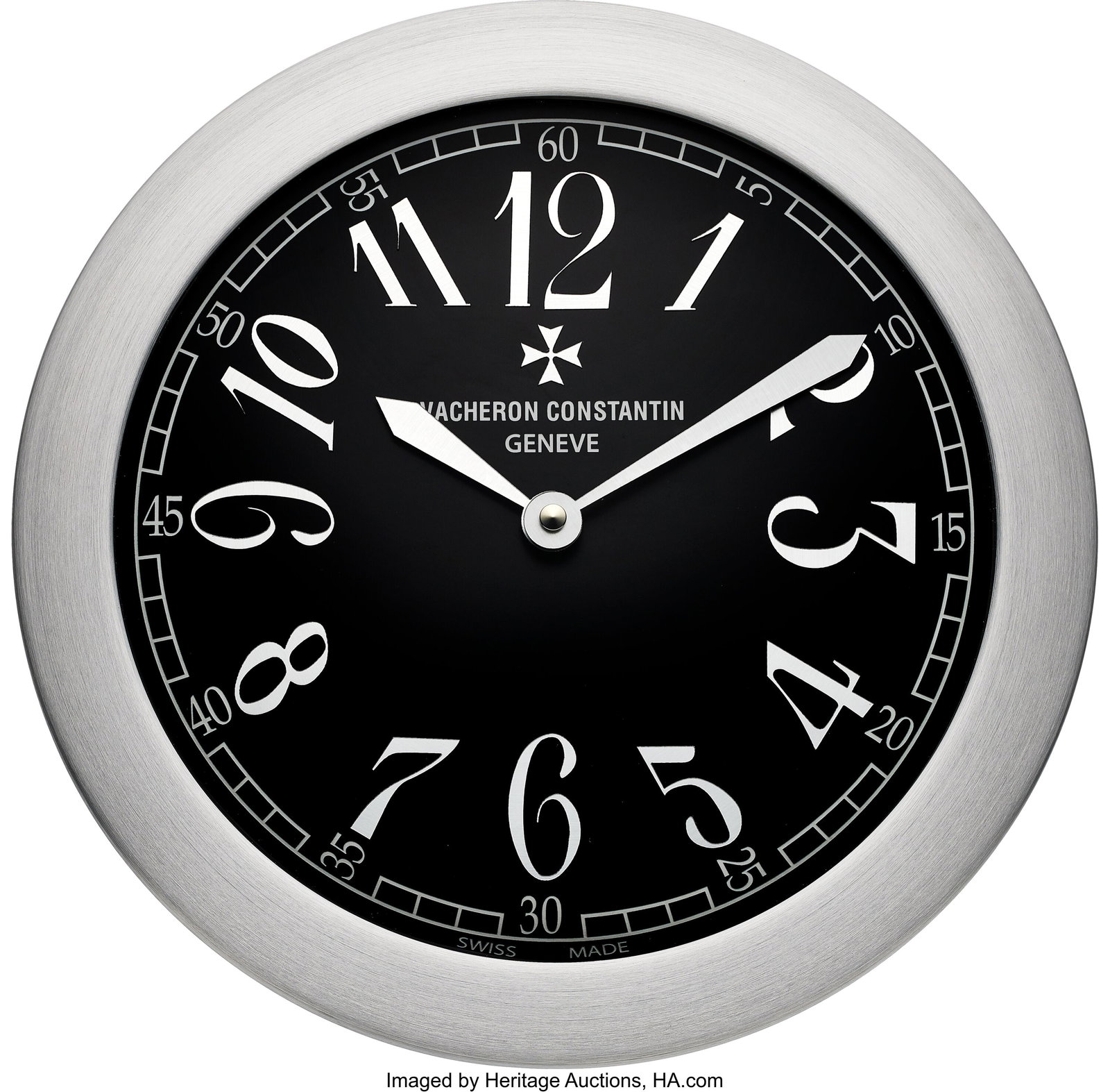 Vacheron Constantin Genève Wall Clock Case: ro: Vacheron Constantin Genève Wall Clock Case: round brushed metal case with wide silver-tone bezel Dial: black dial with oversized silver-tone stylized Arabic numerals, white ou