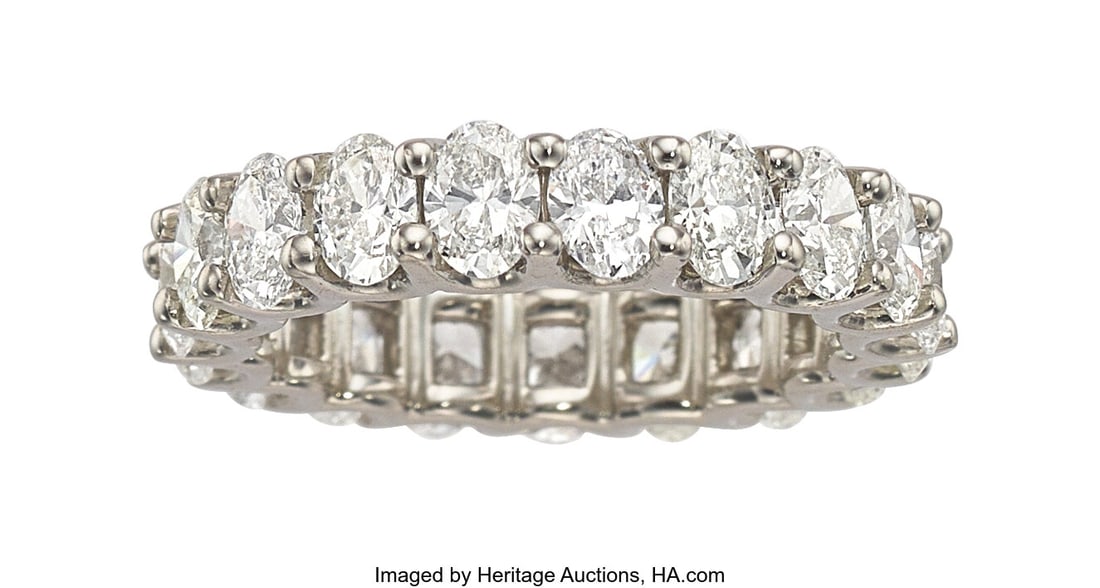 Diamond, Platinum Eternity Band Stones: Oval-sh: Diamond, Platinum Eternity Band Stones: Oval-shaped diamonds weighing a total of 4.53 carats Metal: Platinum Gross Weight: 7.70 grams Size: 6-1/2 (