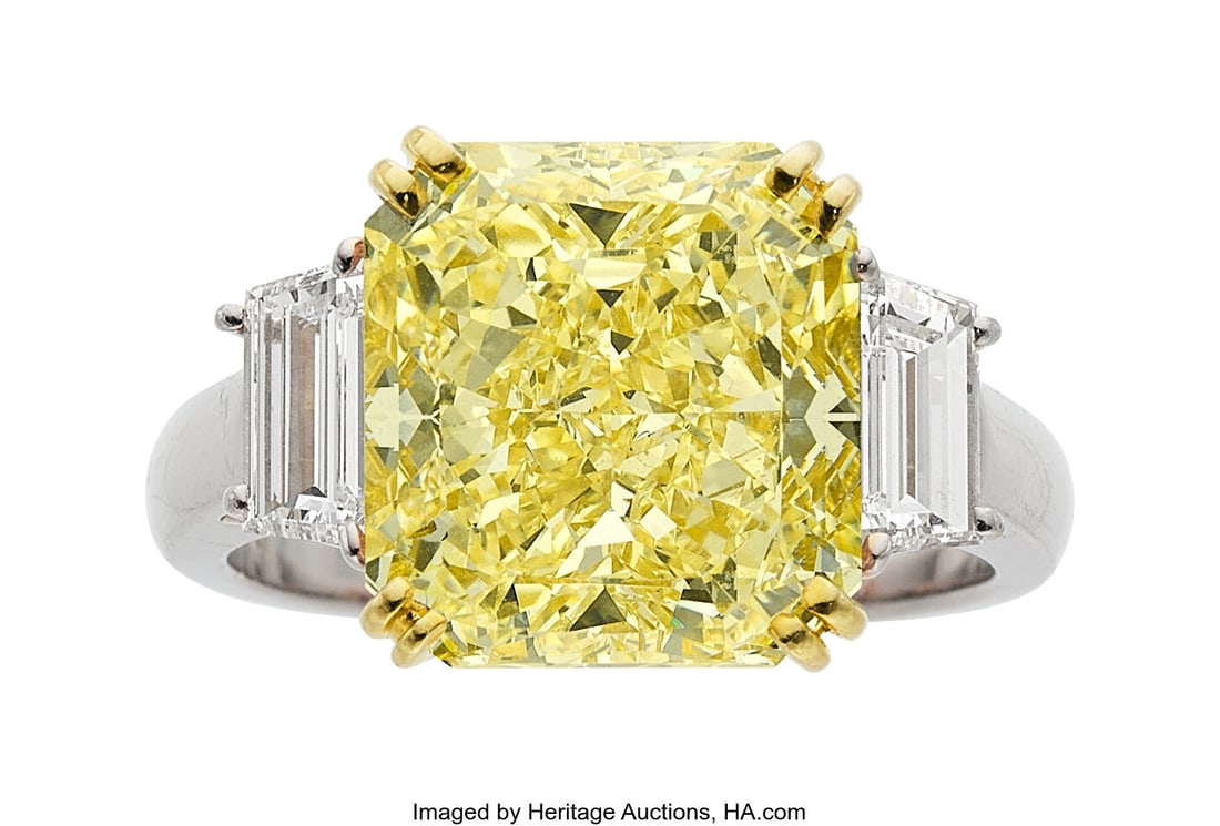Fancy Yellow Diamond, Diamond, Platinum, Gold Ri: Fancy Yellow Diamond, Diamond, Platinum, Gold Ring Stones: Cut-cornered rectangular-shaped fancy yellow diamond weighing 7.41 carats; trapezoid-shaped diamonds weig