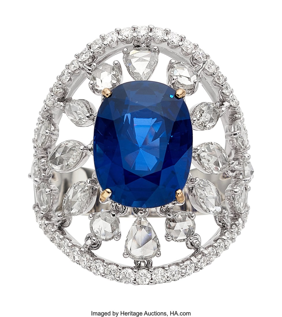 Ceylon Sapphire, Diamond, White Gold Ring Stone: Ceylon Sapphire, Diamond, White Gold Ring Stones: Oval-shaped sapphire weighing 6.69 carats; full-cut diamonds weighing a total of approximately 0.65 carat; r