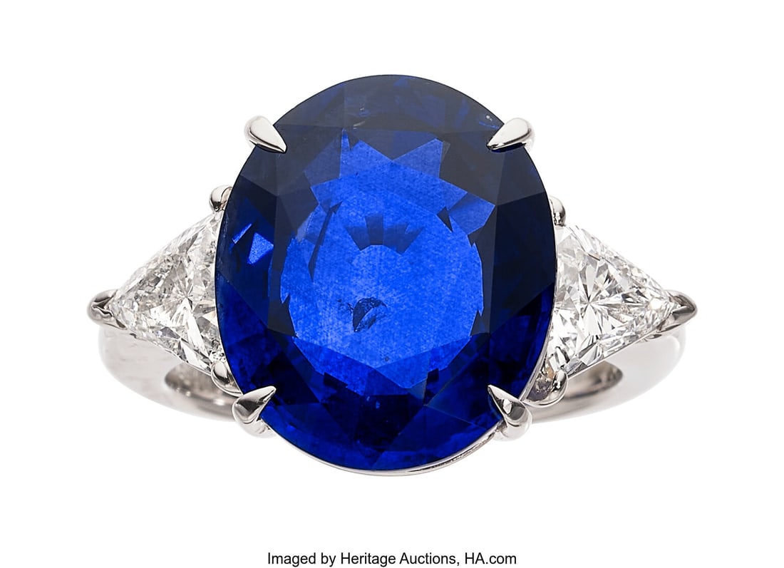 Ceylon Sapphire, Diamond, Platinum Ring Stones:: Ceylon Sapphire, Diamond, Platinum Ring Stones: Oval-shaped sapphire weighing 10.53 carats; triangular-shaped diamonds weighing a total of 1.19 carats Metal: