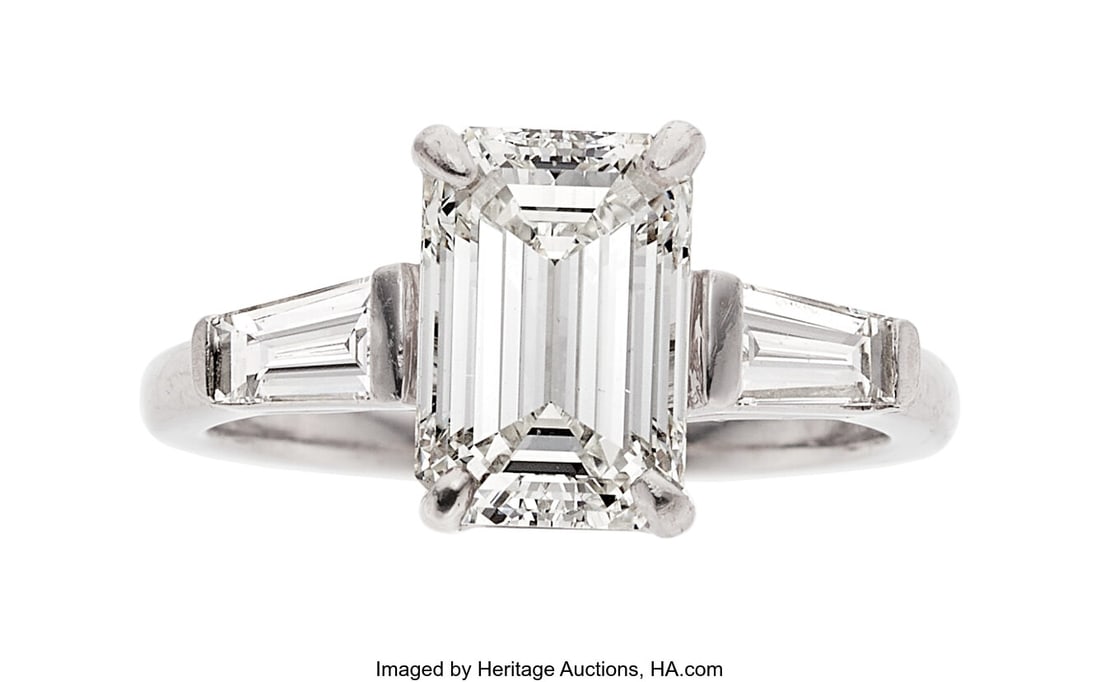 Diamond, Platinum Ring Stones: Emerald-cut diam: Diamond, Platinum Ring Stones: Emerald-cut diamond weighing 2.01 carats; baguette-cut diamonds weighing a total of approximately 0.40 carat Metal: Platinum Gross W