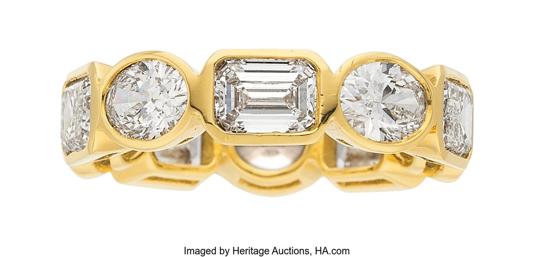 Diamond, Gold Eternity Band Stones: Oval-shaped: Diamond, Gold Eternity Band Stones: Oval-shaped diamonds weighing a total of 2.50 carats; emerald-cut diamonds weighing a total of 3.54 carats Metal: 18k gold Gros