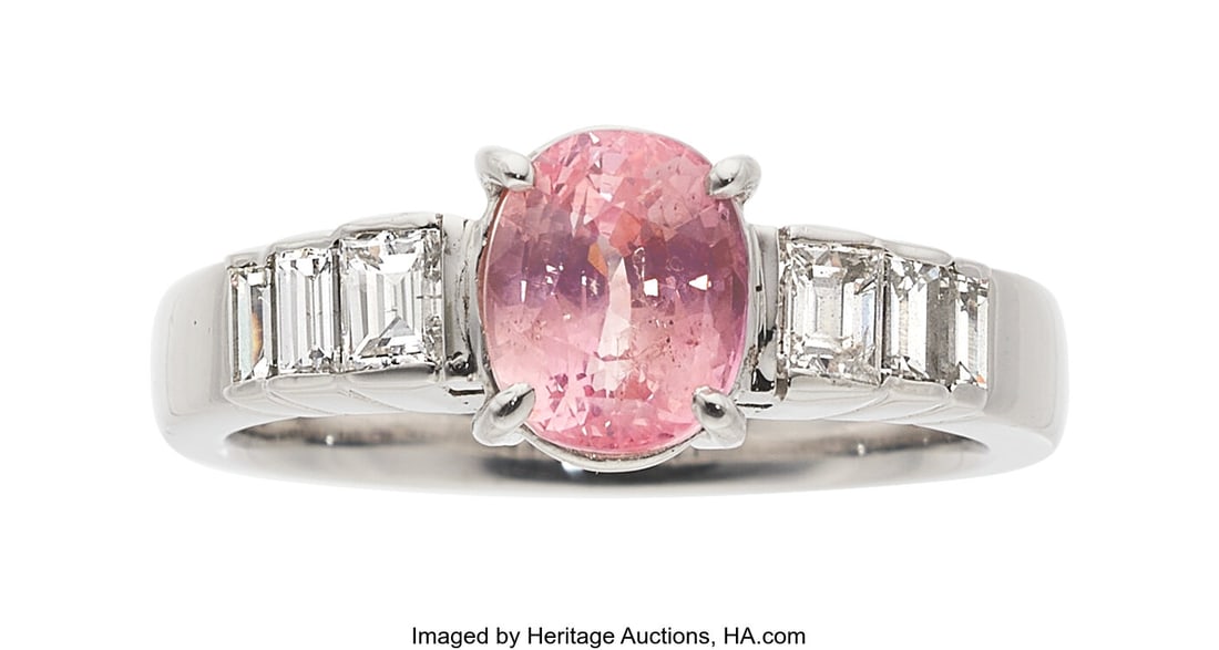 Ceylon Padparadscha Sapphire, Diamond, Platinum: Ceylon Padparadscha Sapphire, Diamond, Platinum Ring Stones: Oval-shaped padparadscha sapphire weighing 2.06 carats; baguette-cut diamonds weighing a total of 0.61