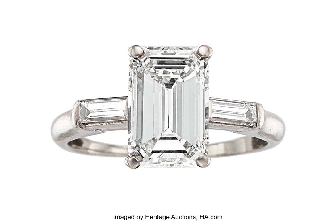 Diamond, Platinum Ring Stones: Emerald-cut diam: Diamond, Platinum Ring Stones: Emerald-cut diamond weighing 2.27 carats; baguette-cut diamonds weighing a total of approximately 0.30 carat Metal: Platinum Gross W