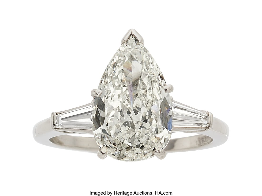 Diamond, Platinum Ring Stones: Pear-shaped diam: Diamond, Platinum Ring Stones: Pear-shaped diamond weighing 2.02 carats; tapered baguette-cut diamonds weighing a total of approximately 0.25 carat Metal: Platinum