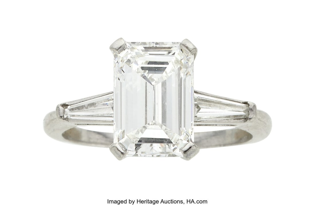 Diamond, Platinum Ring Stones: Emerald-cut diam: Diamond, Platinum Ring Stones: Emerald-cut diamond weighing 2.43 carats; baguette-cut diamonds weighing a total of approximately 0.35 carat Metal: Platinum Gross W