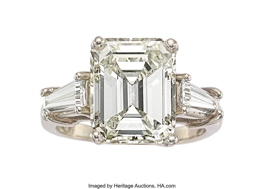 Diamond, Platinum Ring Stones: Emerald-cut diam: Diamond, Platinum Ring Stones: Emerald-cut diamond weighing 4.28 carats; tapered baguette-cut diamonds weighing a total of approximately 0.50 carat Metal: Platinum