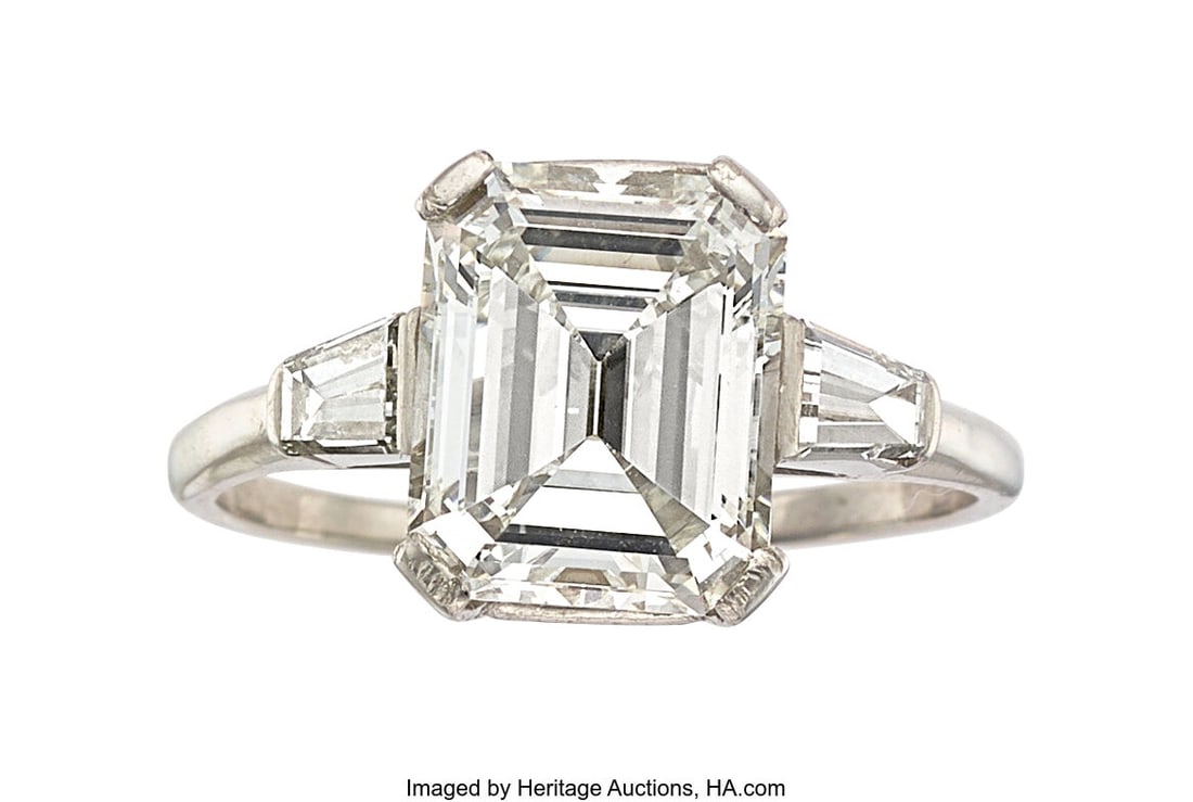Diamond, Platinum Ring Stones: Emerald-cut diam: Diamond, Platinum Ring Stones: Emerald-cut diamond weighing 4.49 carats; tapered baguette-cut diamonds weighing a total of approximately 0.90 carat Metal: Platinum