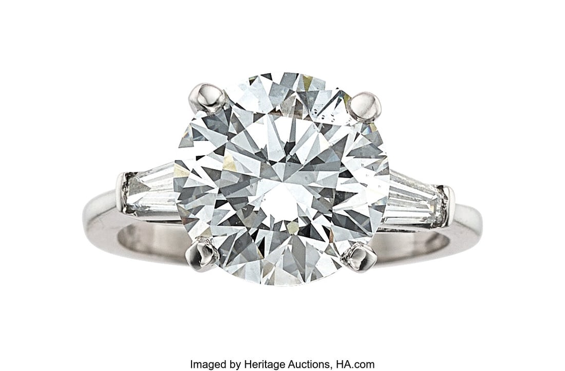 Diamond, Platinum Ring Stones: Round brilliant-: Diamond, Platinum Ring Stones: Round brilliant-cut diamond weighing 4.48 carats; tapered baguette-cut diamonds weighing a total of approximately 0.35 carat Metal: 