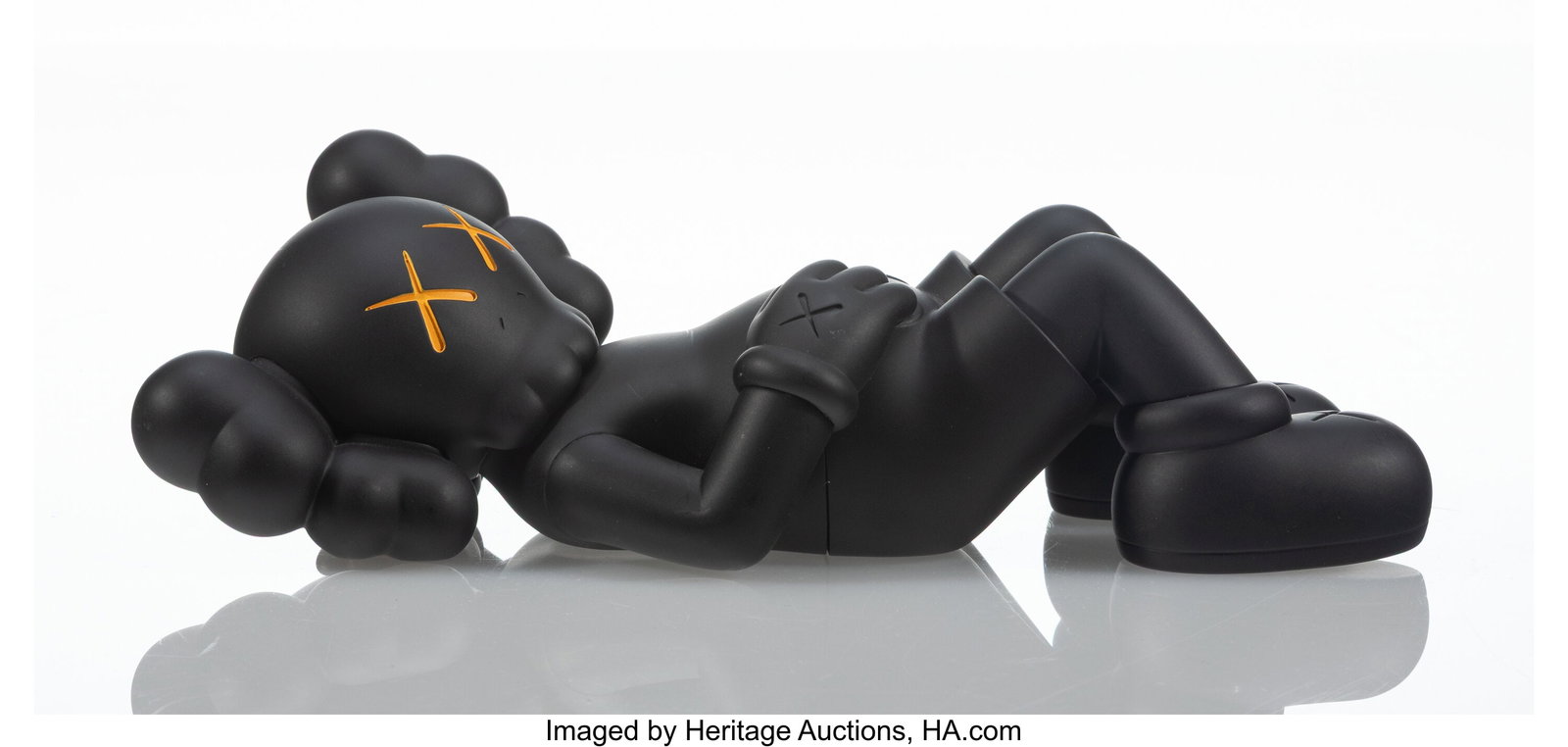 KAWS (b. 1974) Holiday: Japan (Black), 2019 Pain: KAWS (b. 1974) Holiday: Japan (Black), 2019 Painted cast vinyl 2-5/8 x 9-1/2 x 4-1/4 inches (6.7 x 24.1 x 10.8 cm) Sta