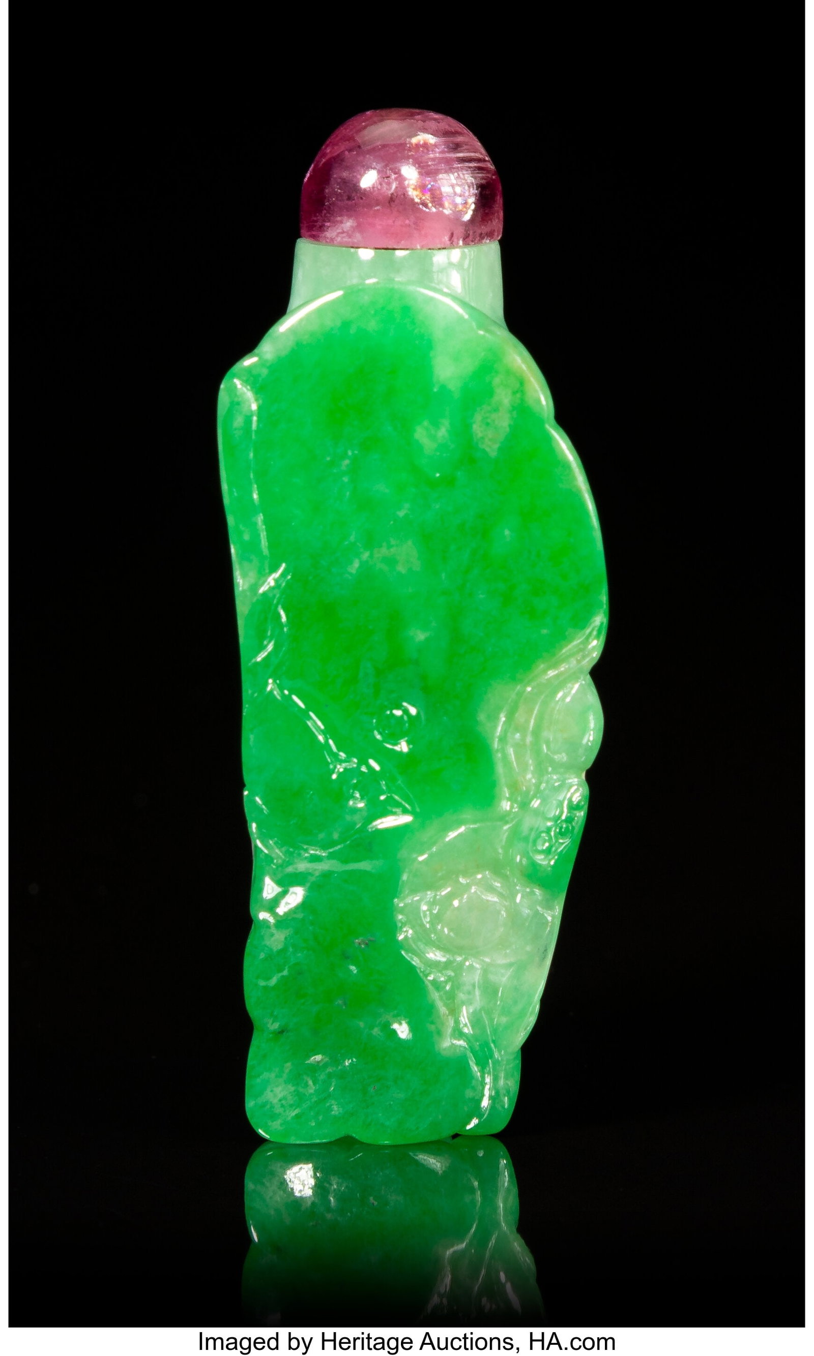 A Chinese Carved Apple Green Jadeite 'Lotus Leaf: A Chinese Carved Apple Green Jadeite 'Lotus Leaf' Snuff Bottle, 19th/20th century 2-1/4 x 1 x 1 inches (5.7 x 2.5 x 2.5 cm) with domed tourmaline stopper P
