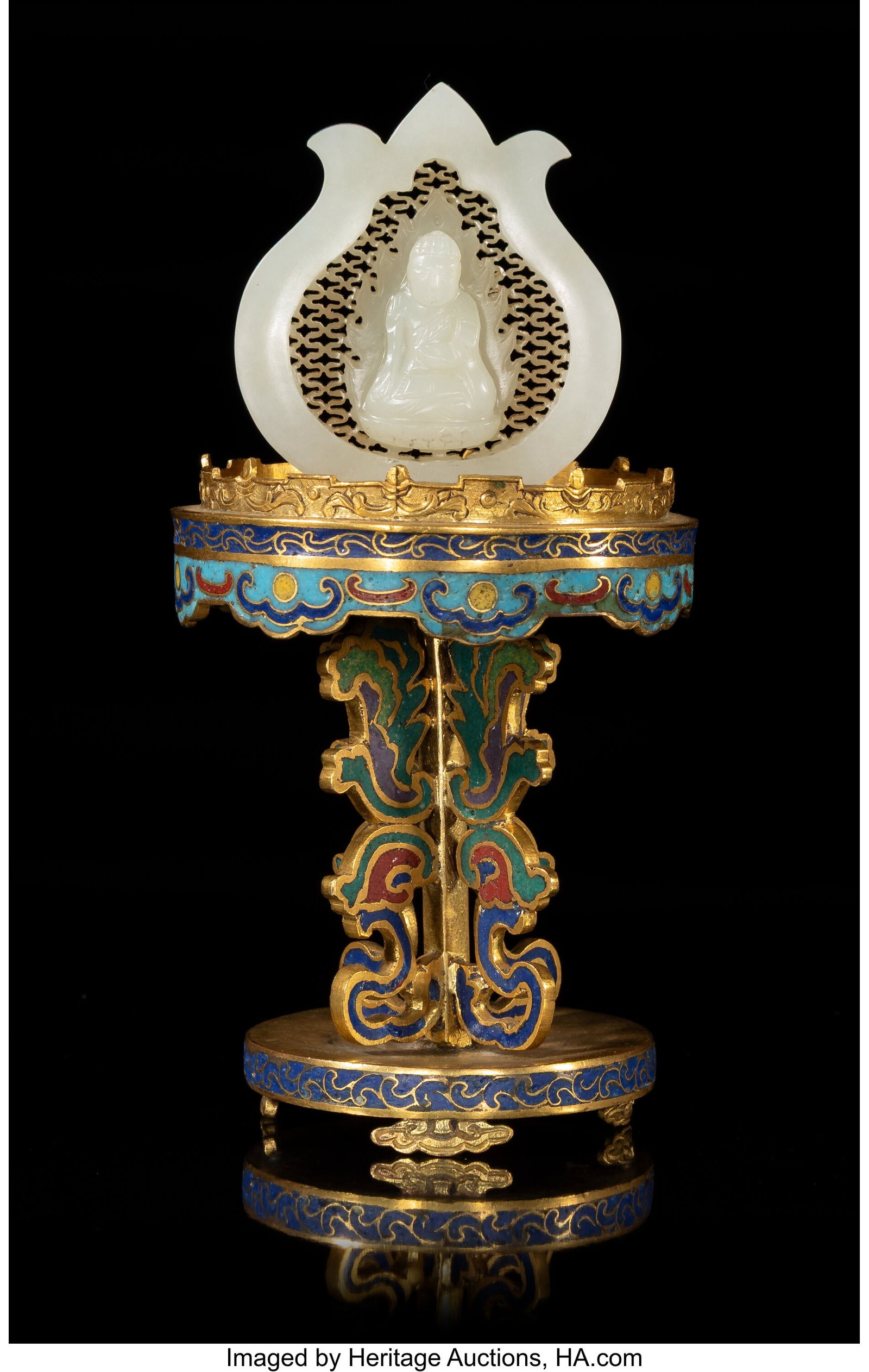 A Chinese Carved White Jade Buddha on Cloisonné: A Chinese Carved White Jade Buddha on Cloisonné Stand, mid-Qing dynasty 3-1/4 x 2-1/2 inches (8.3 x 6.3 cm) (diam., overall) the ret