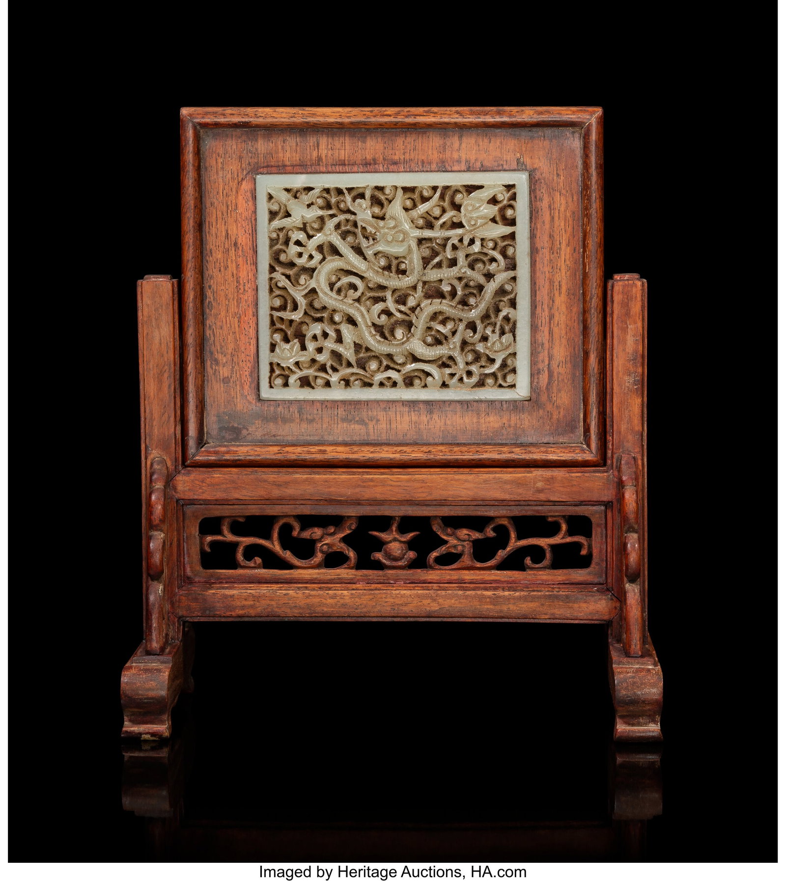 A Chinese Carved Celadon Jade Reticulated 'Drago: A Chinese Carved Celadon Jade Reticulated 'Dragon' Plaque Mounted as Screen, Ming dynasty 2-3/4 x 3-1/4 inches (7.0 x 8.3 cm) (work) 7-1/2 x 6-3&sol