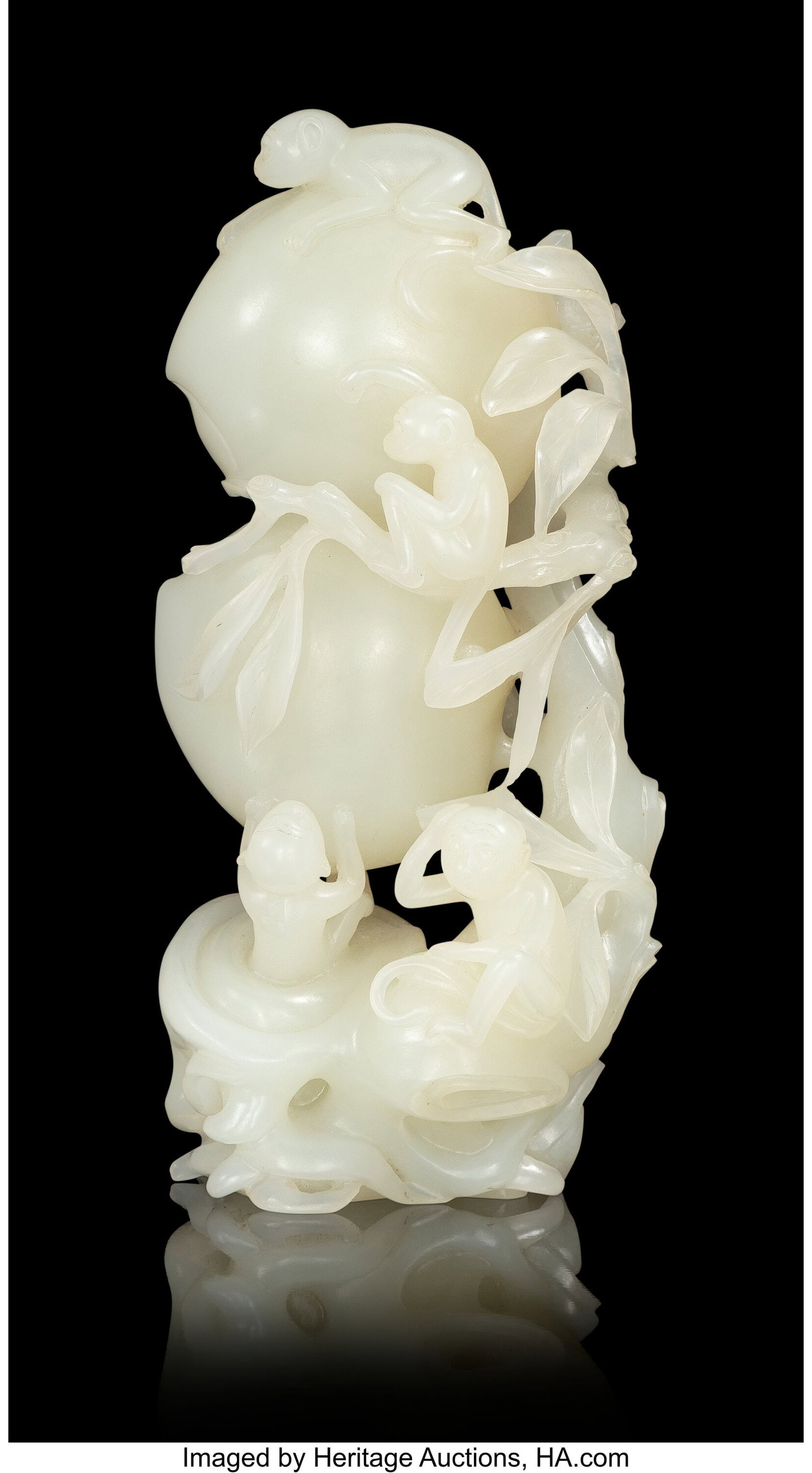 A Chinese Carved Pale Celadon Jade Peaches and M: A Chinese Carved Pale Celadon Jade Peaches and Monkeys, 19th/20th century 5-7/8 x 3 x 2 inches (14.9 x 7.6 x 5.1 cm) intricately carved in the form of a la
