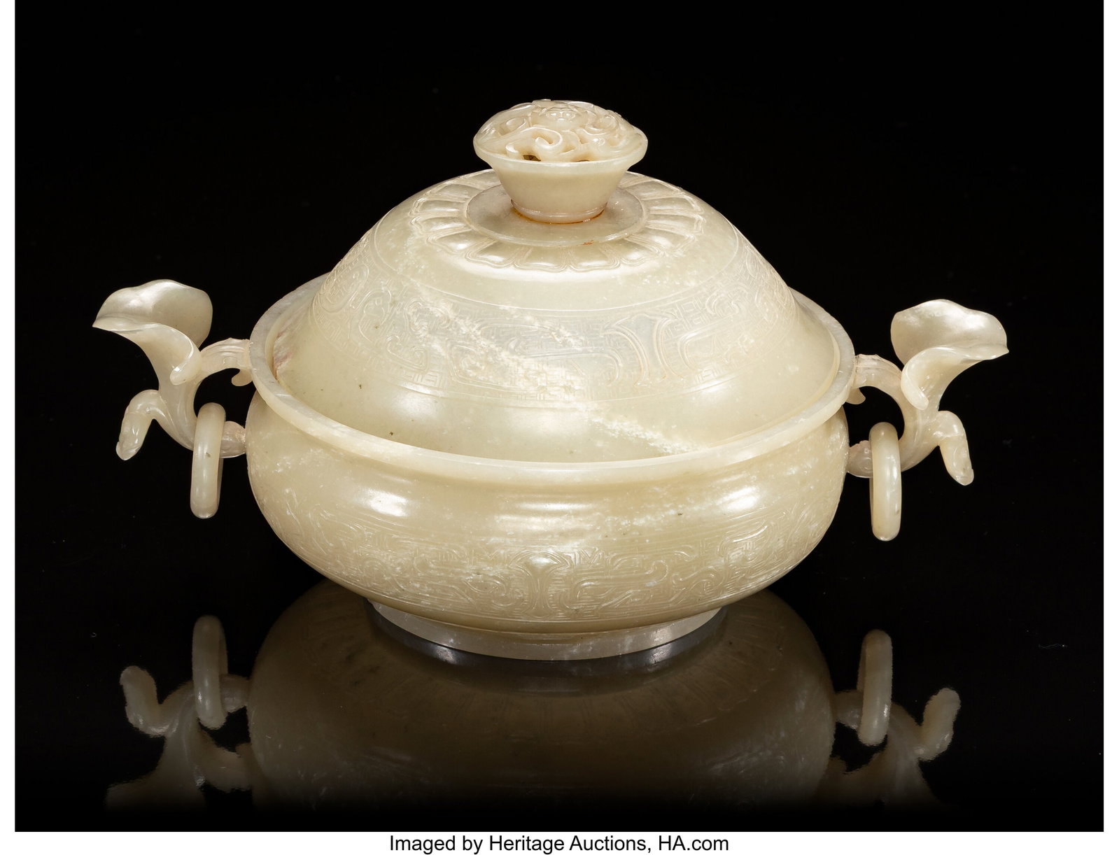 A Chinese Carved Celadon Jade Two-Handled Censer: A Chinese Carved Celadon Jade Two-Handled Censer with Cover, 20th century 4-1/2 x 8-1/2 x 5-1/4 inches (11.4 x 21.6 x 13.3 cm) of compressed form flank