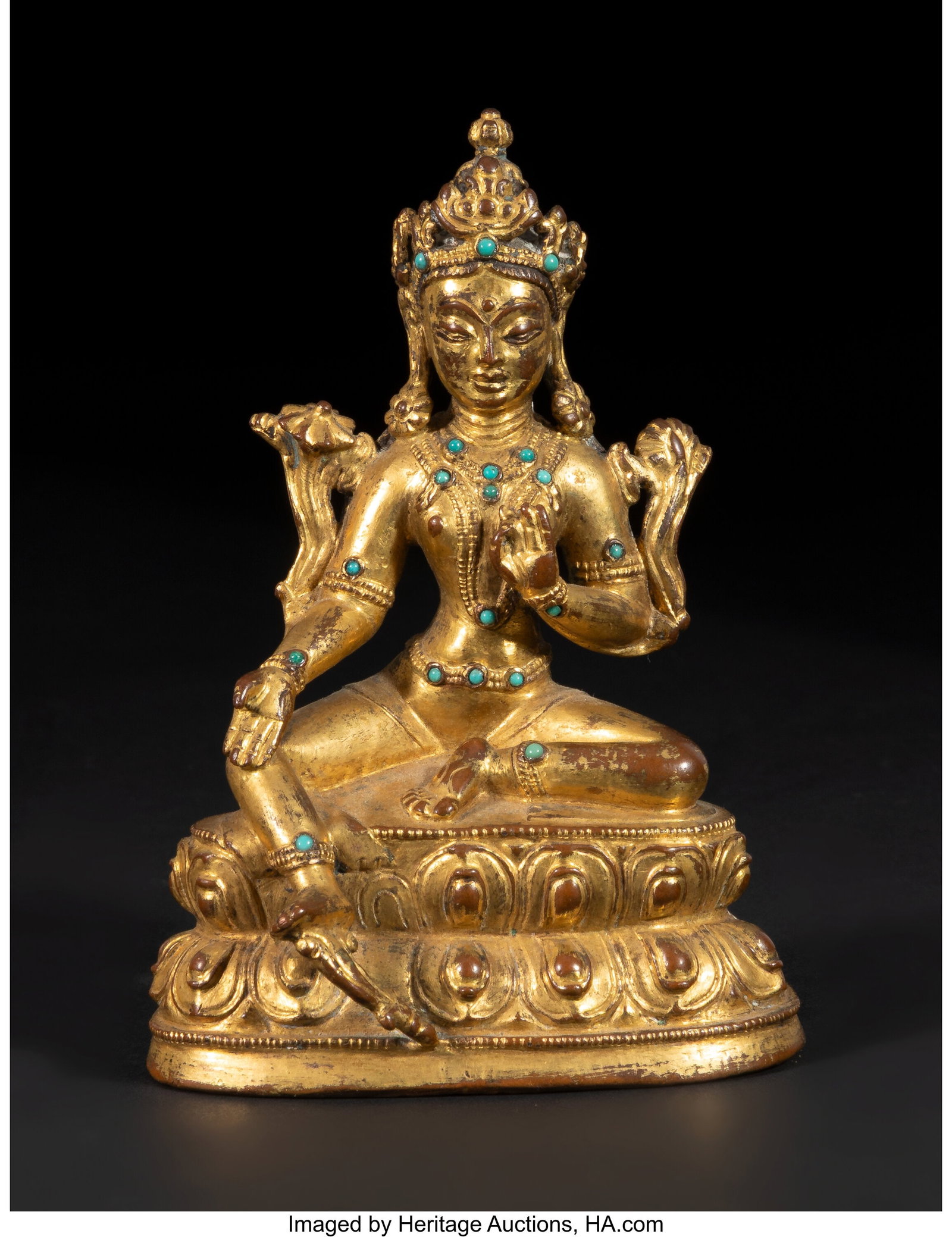 A Tibetan Gilt Bronze Seated Figure of Green Tar: A Tibetan Gilt Bronze Seated Figure of Green Tara, 14th/15th century 4 x 2-7/8 x 1-7/8 inches (10.2 x 7.3 x 4.8 cm) Property from the Estate of George 