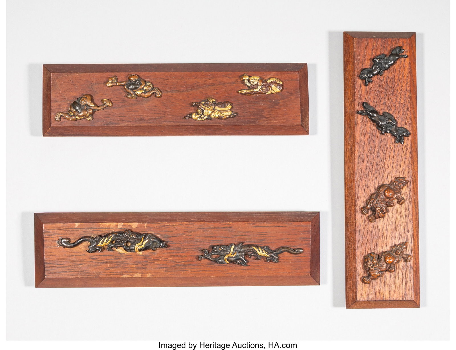 A Group of Ten Japanese Wood-Mounted Menuki 1-7/