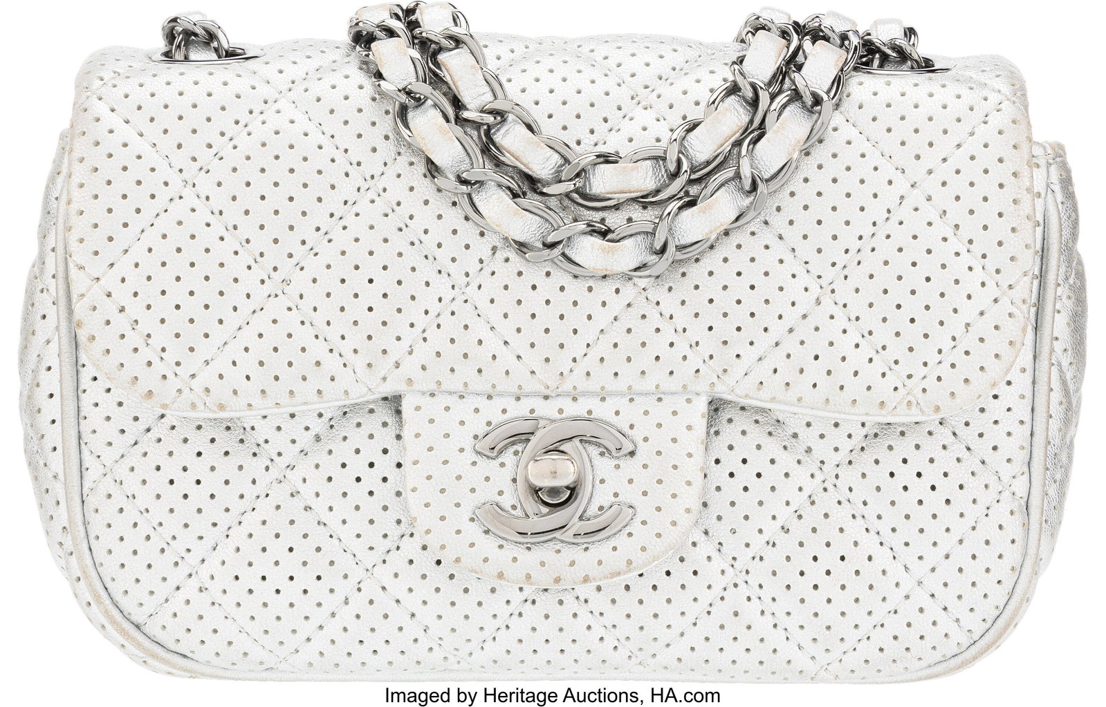 Chanel Metallic Silver Quilted Perforated Lambsk: Chanel Metallic Silver Quilted Perforated Lambskin Leather Mini Flap Bag with Ruthenium Hardware 2014 Condition: 3 8" Width x 5" Height x 2.5" Depth This bag is done in Metallic Silver Pe