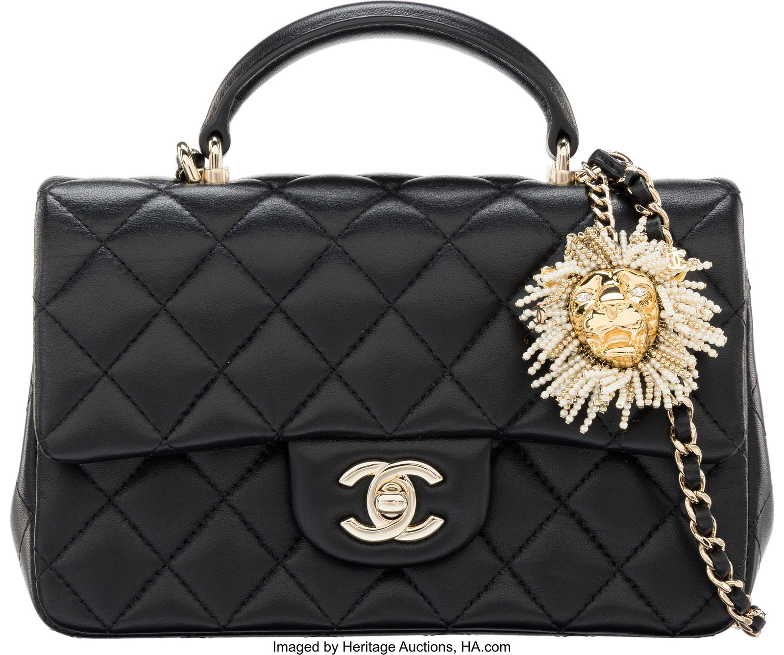 Chanel Black Quilted Lambskin Leather Pearl Lion: Chanel Black Quilted Lambskin Leather Pearl Lion Charm Mini Top Handle Rectangular Flap Bag with Light Gold Hardware Autumn 2023 Condition: 2 7.75" Width x 4.75" Height x 3" Depth 