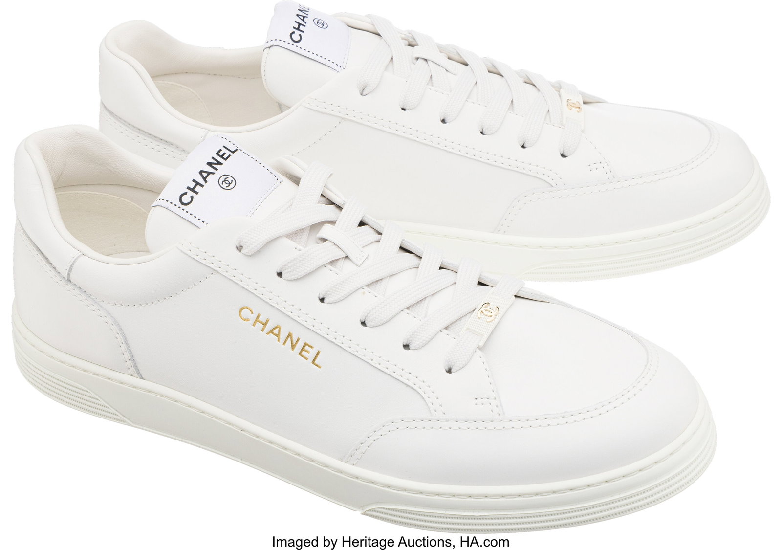 Chanel White Calfskin Leather CC Sneakers Condit: Chanel White Calfskin Leather CC Sneakers Condition: 1 Size 45 These shoes are done in White Calfskin Leather, featuring White laces. There is slight creasing to the uppers. 