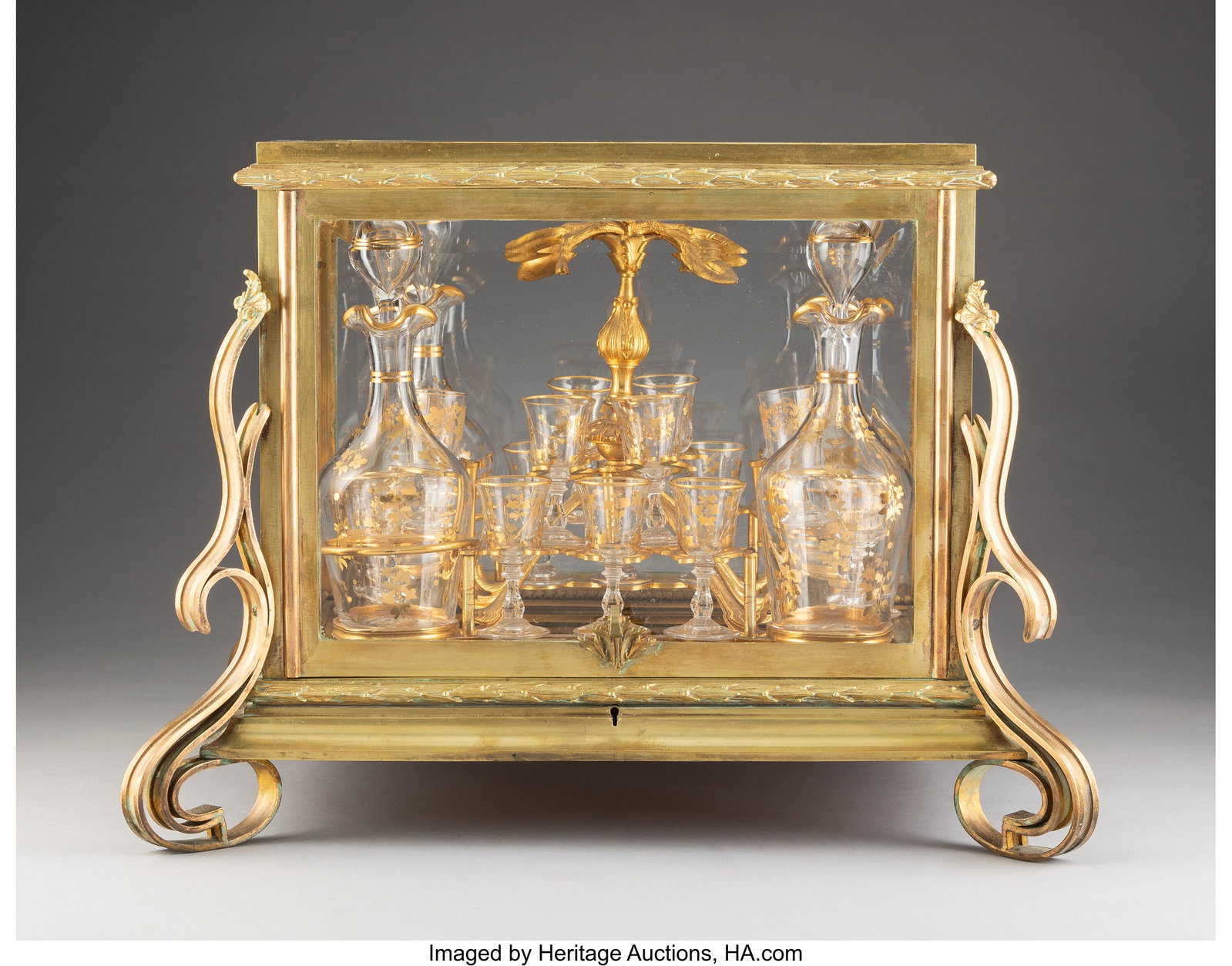 A Louis XV-Style Gilt Bronze-Mounted and Partial: A Louis XV-Style Gilt Bronze-Mounted and Partial Gilt Glass Cave à liquor, late 19th century 8-1/4 x 2-3/4 inches (21.0 x 7.0 cm) (diam.) 