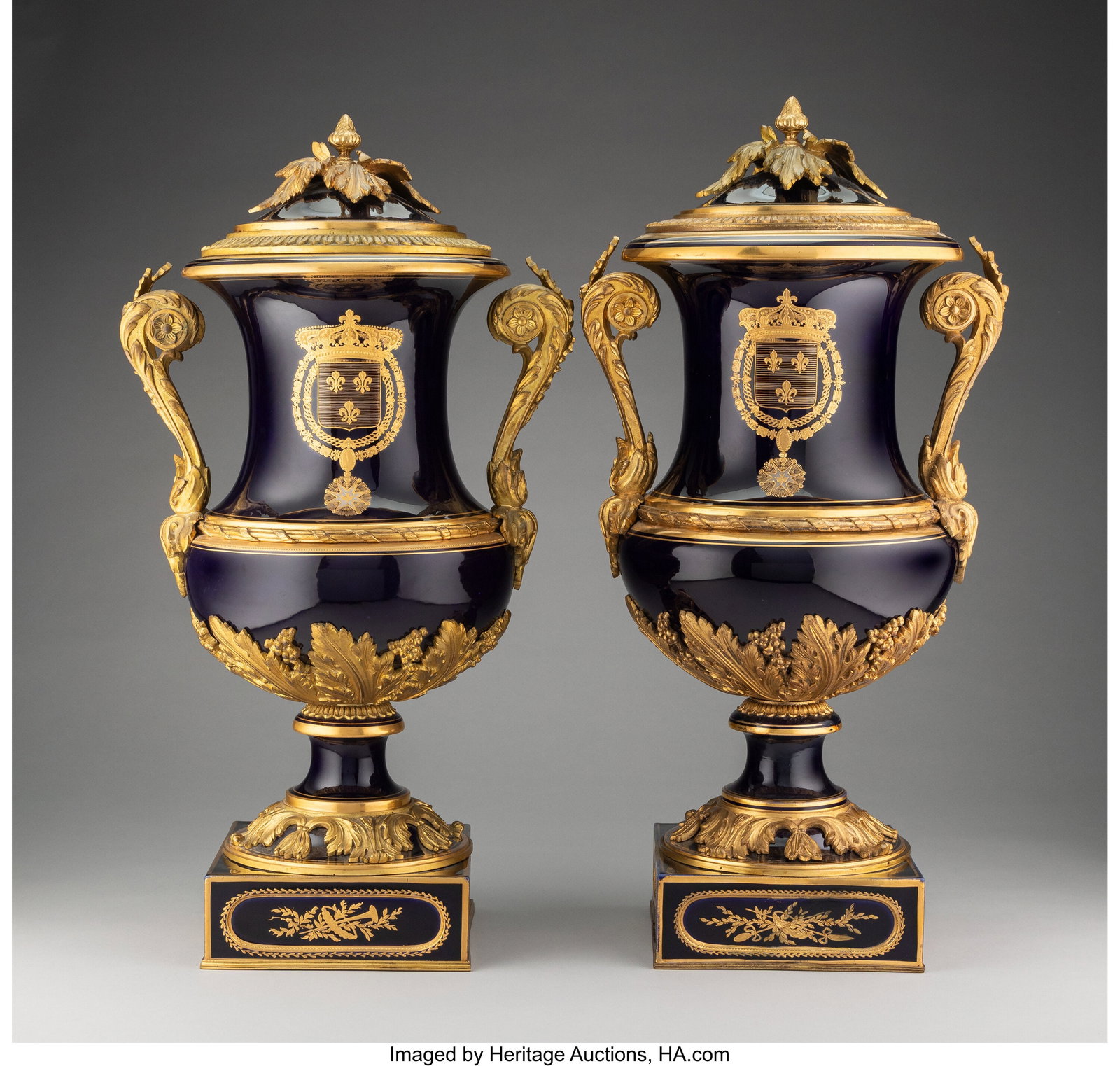 A Pair of Sèvres-Style Gilt Bronze-Mounted and : A Pair of Sèvres-Style Gilt Bronze-Mounted and Cobalt Blue-Ground Porcelain Armorial Covered Two-Handle Vases, late 19th/early 20th century 23 x 10-3/4 x 8-1/2 inches