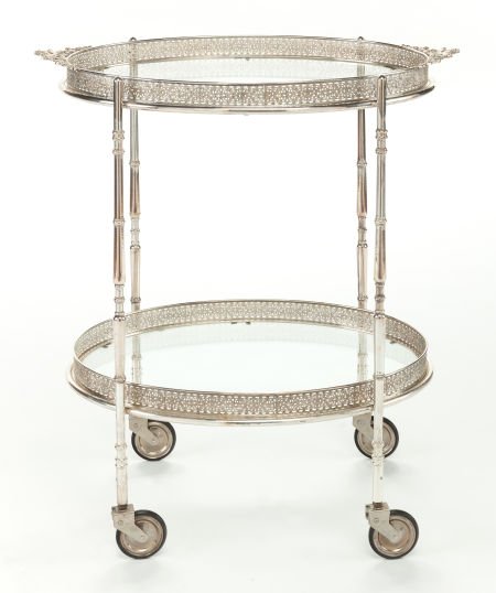 A SILVER-PLATED AND GLASS TEA CART ON CASTORS Ci: A SILVER-PLATED AND GLASS TEA CART ON CASTORSCirca 191030 inches high x 26-3/4 inches