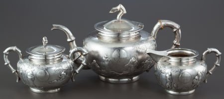 A THREE PIECE GUANG JI CHINESE EXPORT SILVER TEA: A THREE PIECE GUANG JI CHINESE EXPORT SILVER TEA SERVICE Guang Ji, Hong Kong, China, circa