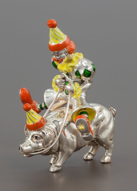 A TIFFANY & CO. SILVER AND ENAMEL CIRCUS CLOWN O: A TIFFANY & CO. SILVER AND ENAMEL CIRCUS CLOWN ON A PIG DESIGNED BY GENE MOORE Tiffany & Co