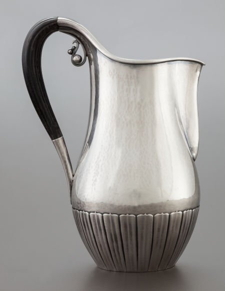 A GEORG JENSEN DANISH SILVER AND EBONIZED WOOD C: A GEORG JENSEN DANISH SILVER AND EBONIZED WOOD CREAM PITCHER DESIGNED BY JOHAN ROHDE 