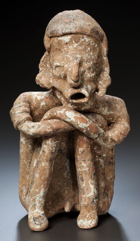 A NAYARIT SEATED FIGURE c. 200 BC - 200 AD: A NAYARIT SEATED FIGUREc. 200 BC - 200 AD The male figure is shown seated with his