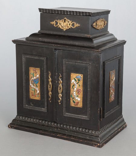 A CONTINENTAL BAROQUE-STYLE EBONIZED WOOD AND EN: A CONTINENTAL BAROQUE-STYLE EBONIZED WOOD AND ENAMELED METAL TABLE CABINET Late 19th/early