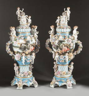 A PAIR OF MONUMENTAL CONTINENTAL PORCELAIN PAINT: A PAIR OF MONUMENTAL CONTINENTAL PORCELAIN PAINTED FLORAL COVERED URNS19th century62 x