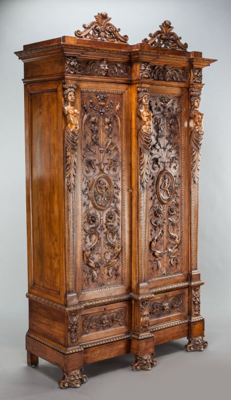 A TUSCAN CARVED WALNUT ARMOIRE 19th century 95-1: A TUSCAN CARVED WALNUT ARMOIRE 19th century 95-1/2 x 55 x 22 inches (242.6 x 139.7 x 55.