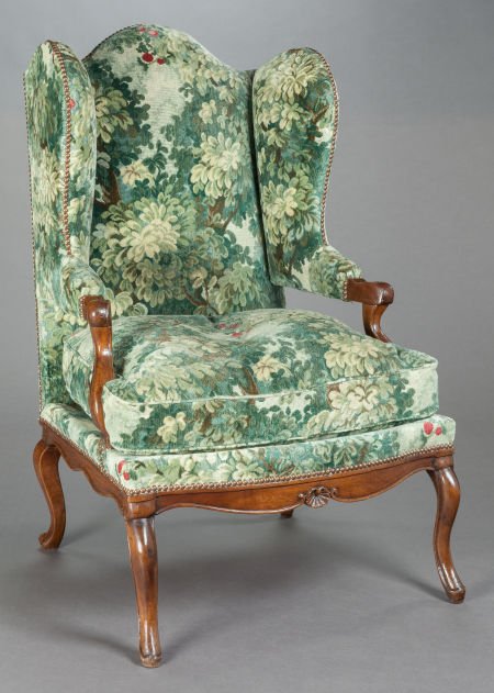 A FRENCH PROVINCIAL WALNUT WING-BACK CHAIR WITH: A FRENCH PROVINCIAL WALNUT WING-BACK CHAIR WITH FLEMISH NEEDLEPOINT UPHOLSTERY20th century