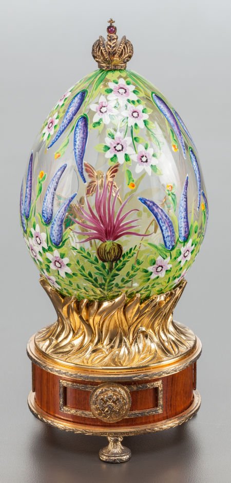 A THEO FABERGÉ ENAMELED GLASS AND GILT METAL BUD: A THEO FABERGÉ ENAMELED GLASS AND GILT METAL BUDDLEIA EGG AND MU