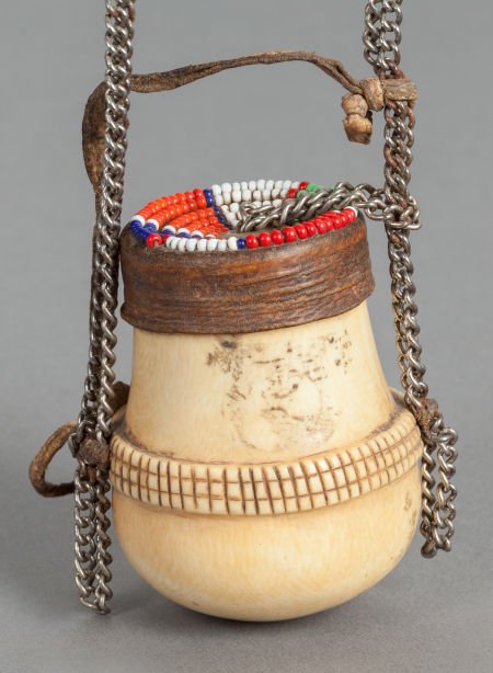 AN AFRICAN IVORY, WOOD AND BEADWORK CONTAINER ON: AN AFRICAN IVORY, WOOD AND BEADWORK CONTAINER ON CHAIN19th/20th centuries2-3/4 inches