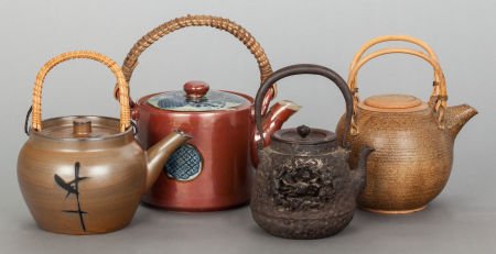 THREE ASIAN-STYLE EARTHENWARE TEA POTS AND A CAS: THREE ASIAN-STYLE EARTHENWARE TEA POTS AND A CAST IRON TEA POT20th century6-1/2 inches